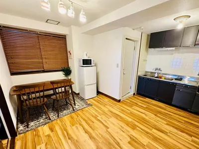 a kitchen with a wooden table and a dining room at AM's 502 Movie 5 min to Ikebukuro 13 min to Shinjuku Station 19 min to Shibuya Station with coworking space in Tokyo