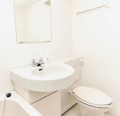 a white bathroom with a sink and a toilet at AM's 502 Movie 5 min to Ikebukuro 13 min to Shinjuku Station 19 min to Shibuya Station with coworking space in Tokyo