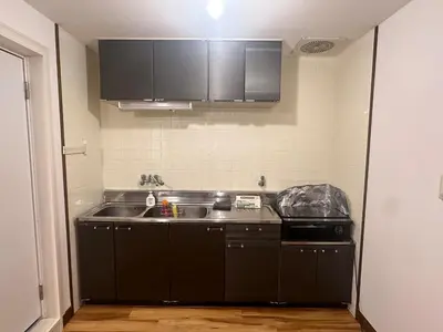 a kitchen with black cabinets and a sink at AM's 502 Movie 5 min to Ikebukuro 13 min to Shinjuku Station 19 min to Shibuya Station with coworking space in Tokyo
