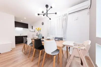 a dining room with a table and chairs at Birthday House Komagome in Tokyo