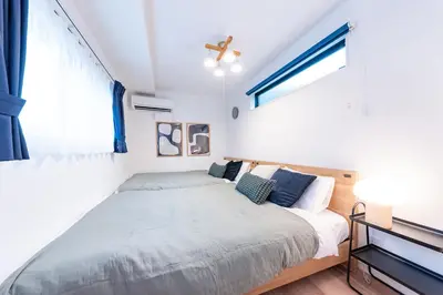 a bedroom with a bed and a window at Birthday House Komagome in Tokyo