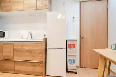 a white refrigerator in a kitchen next to a counter at 70sqm Private House, Major Tokyo Spots & Free Parking in Tokyo