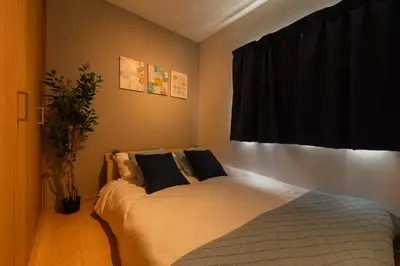 a bedroom with a bed with two pillows on it at 70sqm Private House, Major Tokyo Spots & Free Parking in Tokyo