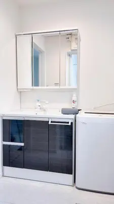 a kitchen with a sink and a mirror at MSTAY\u9ad8\u7530\u99ac\u5834one in Tokyo