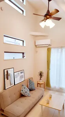 a living room with a couch and a ceiling fan at MSTAY\u9ad8\u7530\u99ac\u5834one in Tokyo