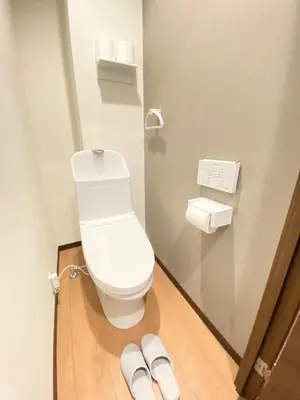 a bathroom with a toilet and a pair of slippers at OHANAJAYAsquare302 in Tokyo