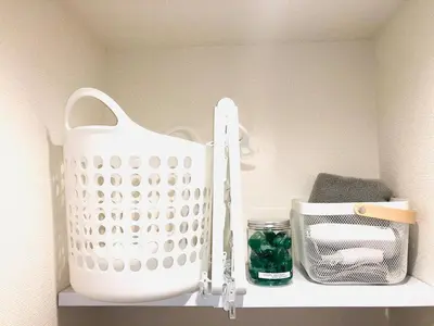 a white basket sitting on top of a shelf at OHANAJAYAsquare302 in Tokyo