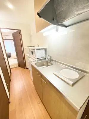 a kitchen with a sink and a microwave at OHANAJAYAsquare302 in Tokyo