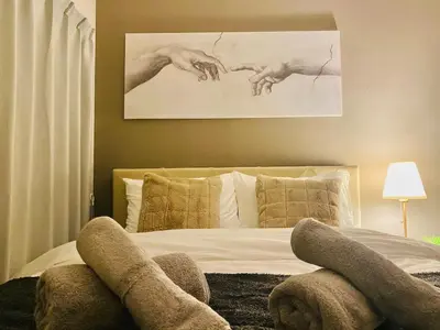 a bedroom with a bed with two hands on it at OHANAJAYAsquare302 in Tokyo