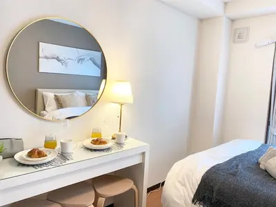 a bedroom with a mirror and two plates of food at OHANAJAYAsquare302 in Tokyo