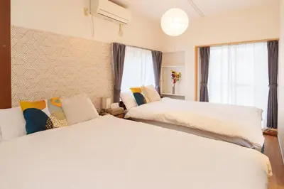 a bedroom with two white beds and a window at 2min from ShinKoiwaSta 13min TokyoSta 14guests 4BR in Tokyo