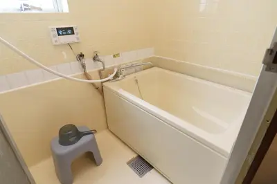 a bathtub in a bathroom with a scale next to it at 2min from ShinKoiwaSta 13min TokyoSta 14guests 4BR in Tokyo