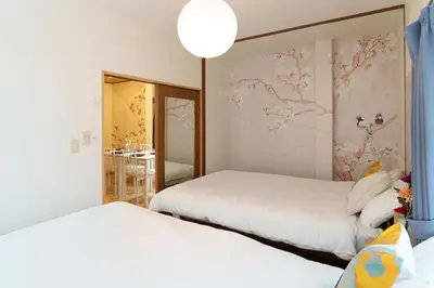 a bedroom with two beds and a wall mural at 2min from ShinKoiwaSta 13min TokyoSta 14guests 4BR in Tokyo
