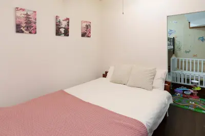 a bedroom with a bed and some pictures on the wall at 2min from ShinKoiwaSta 13min TokyoSta 14guests 4BR in Tokyo