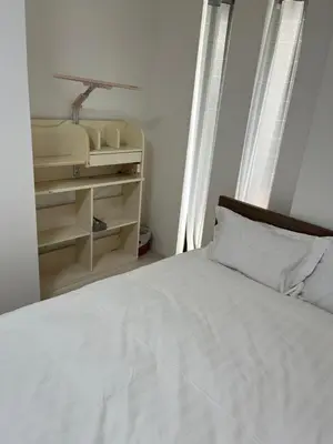 a bedroom with a white bed and a shelf at Tokyo Link House Halona-Direct to Shinjuku, Shibuya, Ginza in Tokyo