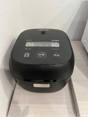 a black device is sitting on a table at Tokyo Link House Halona-Direct to Shinjuku, Shibuya, Ginza in Tokyo