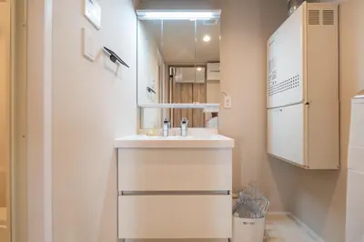 a bathroom with a sink and a refrigerator at Starry Stay Suite Improve Nishimagome in Tokyo