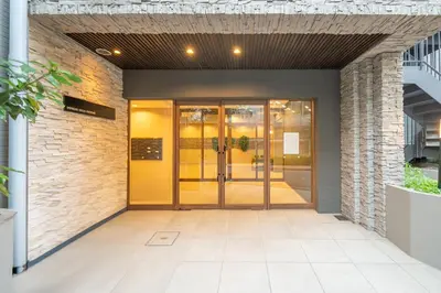 an entrance to a building with a yellow door at Starry Stay Suite Improve Nishimagome in Tokyo