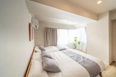 a bedroom with a large bed and a window at Starry Stay Suite Improve Nishimagome in Tokyo