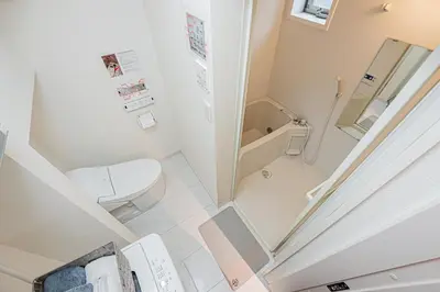 a small bathroom with a toilet and a shower at 8 min walk to JR Chuo Sobu Line Station Ground Floor Room 13 min to Tokyo Direct Train to Asakusa Shinjuku Ueno Akihabara 22sqm in Tokyo