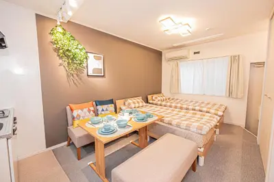 a small living room with a table and chairs at 8 min walk to JR Chuo Sobu Line Station Ground Floor Room 13 min to Tokyo Direct Train to Asakusa Shinjuku Ueno Akihabara 22sqm in Tokyo