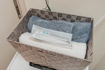 a basket filled with towels and a toothbrush at 8 min walk to JR Chuo Sobu Line Station Ground Floor Room 13 min to Tokyo Direct Train to Asakusa Shinjuku Ueno Akihabara 22sqm in Tokyo