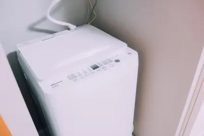 a white refrigerator with a cord attached to a wall at Showa Bloom Cozy Stay Near Shinjuku in Tokyo