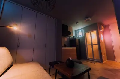 a bedroom with a bed and a table and a door at Showa Bloom Cozy Stay Near Shinjuku in Tokyo