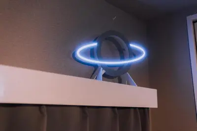 a blue lighted mirror sitting on top of a wall at Showa Bloom Cozy Stay Near Shinjuku in Tokyo