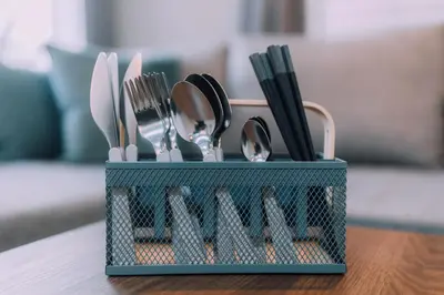 a blue container filled with utensils on a table at Showa Bloom Cozy Stay Near Shinjuku in Tokyo