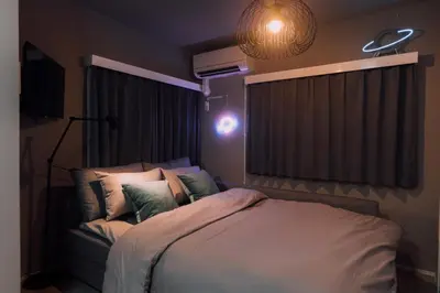 a bedroom with a large bed with pillows at Showa Bloom Cozy Stay Near Shinjuku in Tokyo