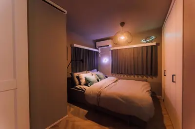 a small bedroom with a bed and a window at Showa Bloom Cozy Stay Near Shinjuku in Tokyo