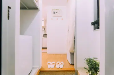 a hallway with two pairs of shoes on the floor at Showa Bloom Stay Near Shinjuku & Yoyogi in Tokyo