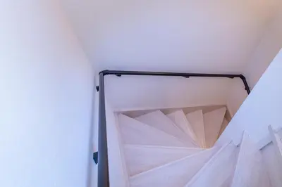 a room with white walls and a white ceiling at \u6771\u5411\u5cf6House in Tokyo