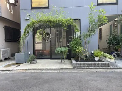 a front door of a building with a bunch of plants at Tokyo Asakusa's Local Side in Wada