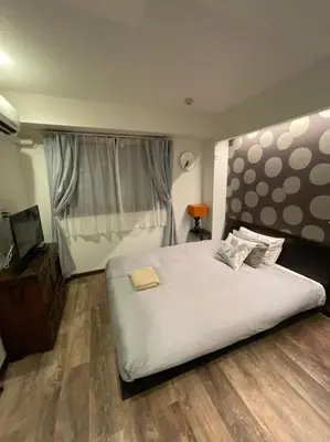 a bedroom with a large white bed and a window at Tokyo Asakusa's Local Side in Wada
