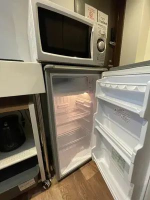 an open refrigerator with a microwave on top of it at Tokyo Asakusa's Local Side in Wada