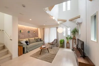 a living room with a couch and a table at Urbané Villa -Kaname House- in Tokyo