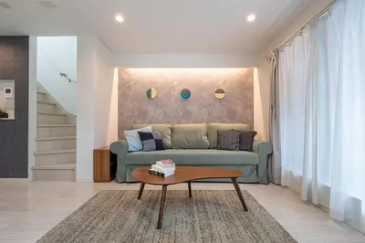 a living room with a couch and a coffee table at Urbané Villa -Kaname House- in Tokyo
