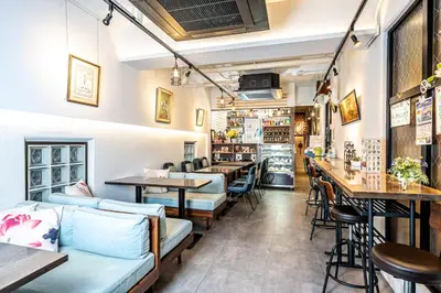 a restaurant with couches and tables and a bar at Kizen Villa in Tokyo