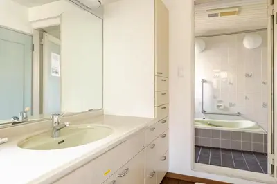 a bathroom with a sink and a mirror at Kizen Villa in Tokyo