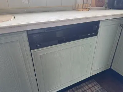 a dishwasher under a counter in a kitchen at Kizen Villa in Tokyo