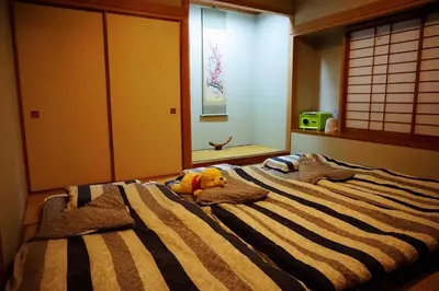 a large bed with a stuffed animal on top of it at Kizen Villa in Tokyo