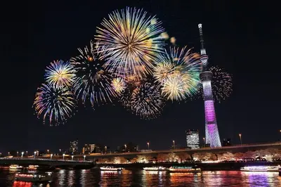a fireworks display with a tower in the background at 602Room, 5 mins walk from JR Kinshicho North Exit!Near Asakusa & Sky Tree!! The house is on the 6th floor with an elevator, convenient transportation There is a balcony and the room is soundproofed in Tokyo