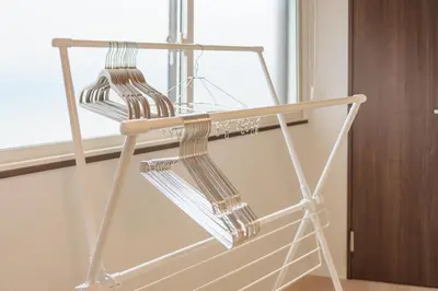 a metal rack with wine glasses on it next to a window at Takasa House in Tokyo