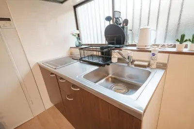 a kitchen counter with a sink and a window at Takasa House in Tokyo