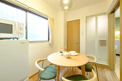 a small dining room with a table and chairs at M-Base Ryogoku Tokyo - Easy Access to Asakusa & Skytree - Steps to Sumo Stadium & Museum in Tokyo