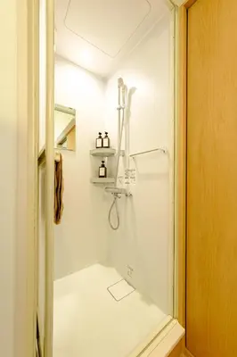 a bathroom with a shower with a glass door at M-Base Ryogoku Tokyo - Easy Access to Asakusa & Skytree - Steps to Sumo Stadium & Museum in Tokyo