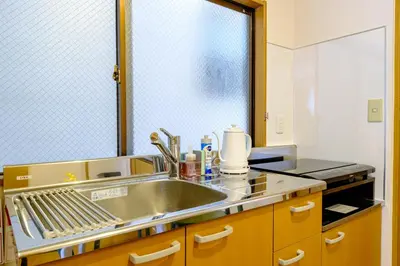 a kitchen with a sink and a mirror at M-Base Ryogoku Tokyo - Easy Access to Asakusa & Skytree - Steps to Sumo Stadium & Museum in Tokyo