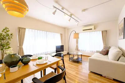 a living room with a table and a couch at M-Base Ryogoku Tokyo - Easy Access to Asakusa & Skytree - Steps to Sumo Stadium & Museum in Tokyo